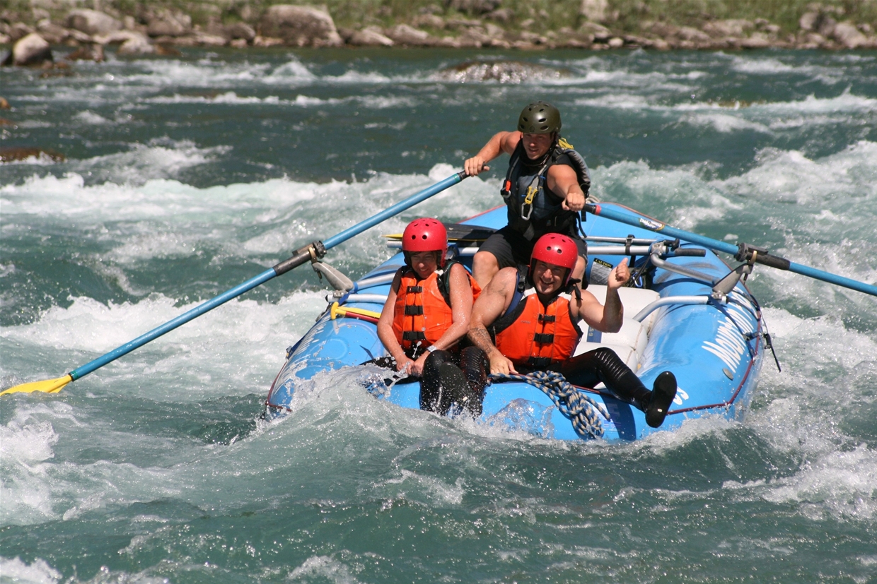 Guests riding the bull on Fernie's classic white water rafting trip