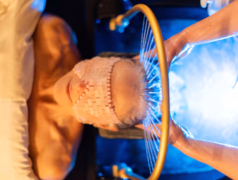 Woman receiving a Japanese Head Spa treatment with a mask on her face.