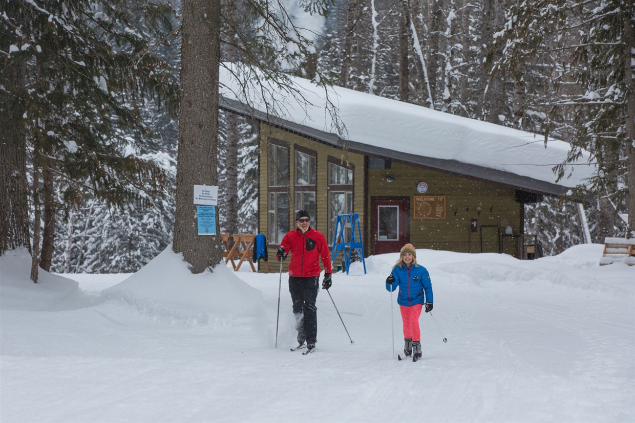 Elk Valley Nordic Centre - Father & daughter xc skiing from warming hut