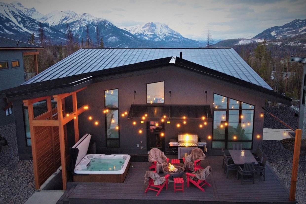 Exterior deck with hot tub and fire pit at Fernie Mountain House